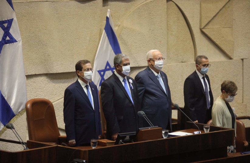 Isaac Herzog (L) is seen with Knesset Speaker Mickey Levy and outgoing President Reuven Rivlin at the former's inauguration as Israel's 11th president in the Knesset, on July 7, 2021. (photo credit: MARC ISRAEL SELLEM/THE JERUSALEM POST)