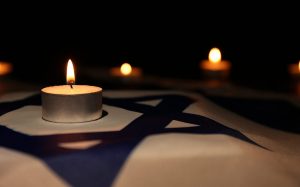 Burning candle flag of Israel. Holocaust memory day 1140x712 1