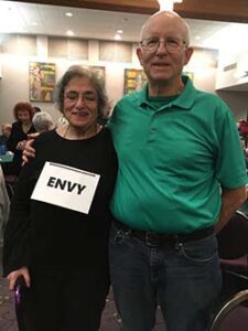 Phil Lorang at a Purim party with his late wife Ellen. The couple in a visual pun depicted the expression “Green with Envy.” [Lorang family photo]