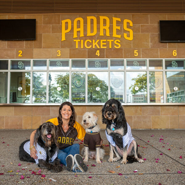 Kira Finkenberg is a fan of the San Diego Padres and so, apparently, are her three dogs. (Family photo]