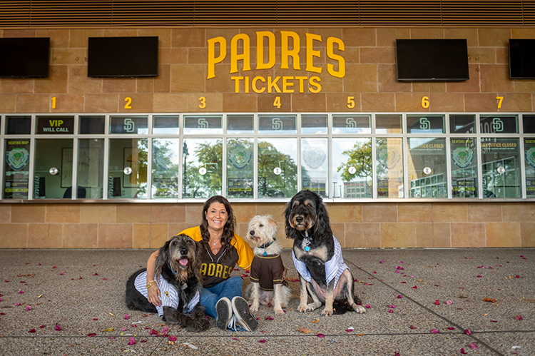 Kira Finkenberg is a fan of the San Diego Padres and so, apparently, are her three dogs. (Family photo]